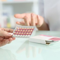 Girl buying contraceptive pills in a pharmacy