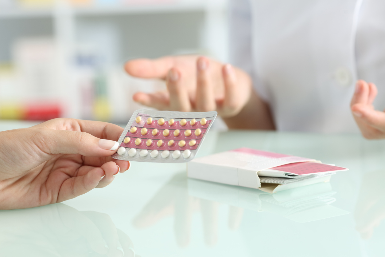 Girl buying contraceptive pills in a pharmacy