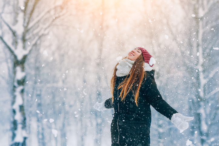 Winter young woman portrait. Beauty Joyful Model Girl laughing and having fun in winter park. Beautiful young woman outdoors. Enjoying nature, wintertime